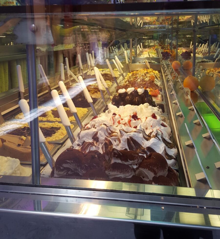 Multiple flavors of gelati displayed in a freezer case